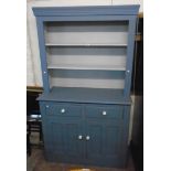 A 4' 1" painted wood two part dresser with two shelf open plate rack over a base with two drawers