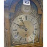 A 20th Century polished oak cased grandmother clock with decorative arched dial and Elliott eight