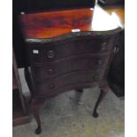 A 20 1/2" reproduction flame mahogany veneered serpentine front chest of three long drawers, set