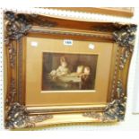 An ornate gilt framed and slipped oil on panel, depicting three children looking at puppies in a