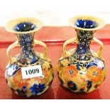 A pair of early 20th Century H. & R. Carlton Ware Best two handled bottle vases - one a/f