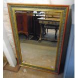 A decorative gilt and part painted framed bevelled oblong wall mirror