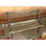 A child's garden bench with wooden slats and cast iron ends - length 3'