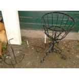 A wrought iron pedestal plant stand - sold with another in the form of a bicycle