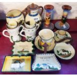 A collection of souvenir Torquay pottery including Minehead candlesticks with stag decoration, St.