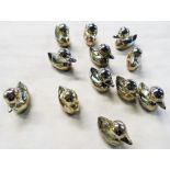 A set of twelve silver plated duck pattern table place markers