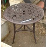 A cast metal circular garden table on tripod base - diameter 26"