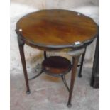 A 27" diameter Edwardian stained walnut two tier occasional table with moulded edges and slender