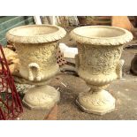 A pair of 27" diameter cast concrete garden urns with rope pattern handles and repeat scroll