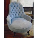 A late Victorian tub chair with later button back blue velour upholstery, set on turned front legs