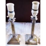 A pair of silver plated column table lamps