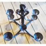 An antique wrought iron eight branch candle prick chandelier