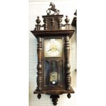 An early 20th Century stained wood cased Vienna style wall clock with prancing horse pediment,