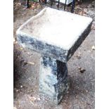 A black painted concrete birdbath