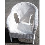 A vintage white painted wicker and cane framed patio tub chair