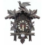 A vintage stained and carved wood cuckoo clock - one numeral and weight loop missing