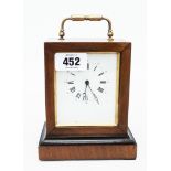 A 19th Century walnut and part ebonised cased bedside timepiece with brass carrying handle and