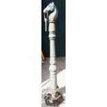 A painted cast iron garden ornament in the form of a tethering post with horse head finial -