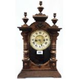 A late 19th Century stained wood cased American shelf clock with turned spindles and half column