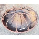 A cast iron Mexican hat pig feeder with dividers - 35" diameter