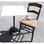 A 23 1/2" painted wood topped garden table, set on a cast iron tripod base - sold with an early 20th