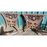 A pair of ornate cast iron table ends with lion mask bosses - top width 24 3/4"