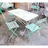 A 3' 3 1/2" vintage French style café folding table and set of four chairs, with remains of original