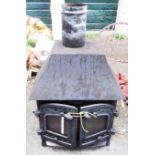 A Villager cast iron wood burning stove - hood width 23"