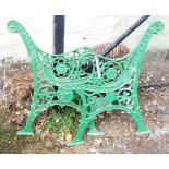 A pair of later green painted cast iron bench ends