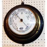 An early 20th Century oak mounted brass cased bulkhead aneroid wall barometer with printed ceramic
