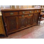 A 5' 6" Edwardian stained walnut sideboard with three frieze drawers, further central drawer and