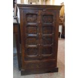 A 20 1/2" eastern hardwood cabinet enclosed by a pair of decorative carved panel doors featuring