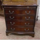 A 28" reproduction mahogany and cross banded serpentine front bachelor's chest with brushing slide