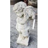 A concrete garden statue in the form of a putto playing a tambourine - height 24"