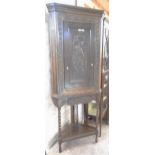 A 33" carved and polished oak corner cabinet with decorative perching pheasant and oak leaf