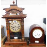 An early 20th Century stained wood and metal mounted cased American shelf clock with silvered dial