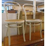 A pair of vintage painted bentwood chairs with rattan seat panels