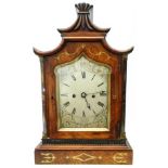 A Regency brass inlaid mahogany cased table clock with stylised oriental pediment, the 6 1/4" shaped