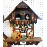A 20th Century automaton cuckoo clock with moving figures and triple weight driven movement - two