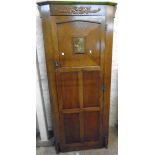 A 32 1/2" 20th Century polished oak hall wardrobe with applied moulded and pressed metal decoration,