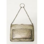 An early 20th Century Birmingham silver double purse with engine turned decoration, suspender chain,