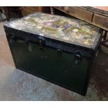 A vintage metal bound travelling trunk with decoupage decoration to top