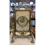 A late Victorian ornate cast brass framed timepiece with decorative dial and platform escapement