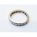 An unmarked white metal and diamond set eternity ring