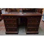 A 4' 4" Victorian mahogany kneehole desk with rexine inset top and eight flanking pedestal