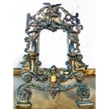 A Victorian ornate pierced and gilt cast iron picture frame with swivel easel and registration