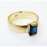 A yellow metal blue stone ring