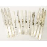 A set of six each silver Mappin & Webb fruit knives and forks with silver collars and mother-of-