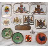 A collection of assorted enamelled wall plaques depicting various coat of arms, two cloisonné pin