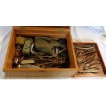 A box containing a collection of vintage medical instruments including tourniquet, tongue depressor,